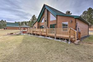 a log cabin with a deck and a house at Scenic Hill City Cabin Hiking and ATV Trail Access in Hill City