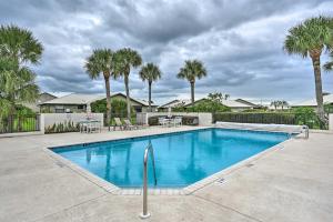 a swimming pool in a yard with palm trees at Condo with Screened-in Porch, 1 Mi to Sebring Golf! in Sebring