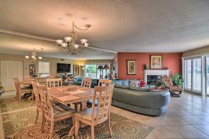 a living room with a table and a couch at Beachfront Indian Shores Condo - Pool and Hot Tub! in Clearwater Beach