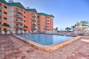 a swimming pool in front of a building at Beachfront Indian Shores Condo - Pool and Hot Tub! in Clearwater Beach