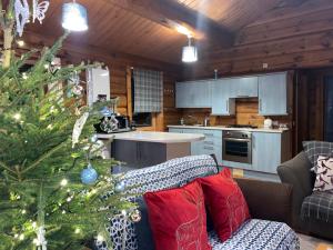 a kitchen with a christmas tree in a living room at Log home village in Ulverston