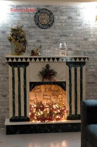 a fireplace with a christmas tree on top of it at Rossi Hotel in Rome