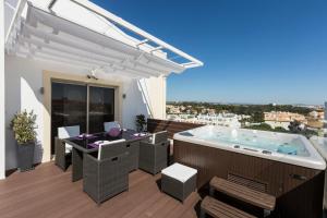 a hot tub on the deck of a house at D_Loft in Albufeira