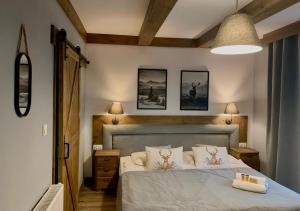 a bedroom with a bed and two pictures on the wall at Willa Donia in Ustroń