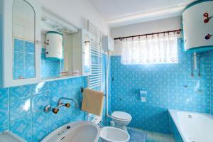 a blue bathroom with a sink and a toilet at Apartments Diego in Sveti Juraj +35 photos