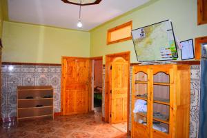 a room with green walls and wooden cabinets and a room with a room at Dar Akiode Toubkal in Imlil
