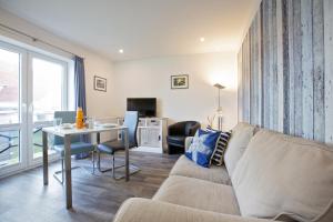 a living room with a couch and a table at Appartements Hafen 31 in Wittdün