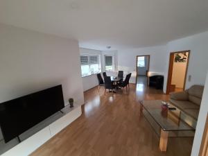 a living room with a couch and a table at Ferienwohnung in Troisdorf Nähe Flughafen Köln Bonn in Troisdorf