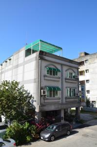 a building with a car parked in front of it at East of Love Homestay in Hualien City