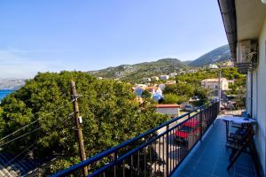 a balcony with a view of a town and the ocean at Apartments Diego in Sveti Juraj