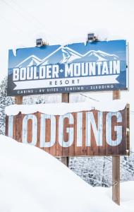 a sign for a boulder mountain resort in the snow at Boulder Mountain Resort in Revelstoke