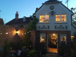 a house with a clock on the top of it at The Clock House in Chichester