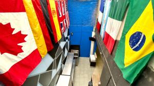 a hallway with flags hanging in a room at ROOMIES HOSTEL Roma in Mexico City