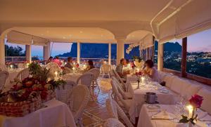 a dining room filled with tables and chairs at Hotel Villa Brunella in Capri