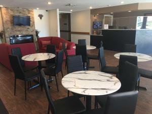 a restaurant with tables and chairs and a couch at SureStay Hotel by Best Western Weimar in Weimar