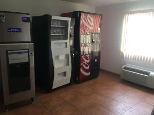 two cocacola machines are next to each other at SureStay Hotel by Best Western Weimar in Weimar