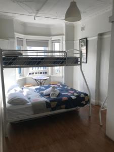 a bedroom with a bunk bed in a room at Highfield Private Hotel in Sydney