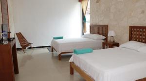 Voodi või voodid majutusasutuse Hotel Itza Coba toas