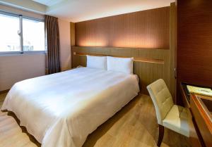 Postel nebo postele na pokoji v ubytování Talmud Hotel Tainan