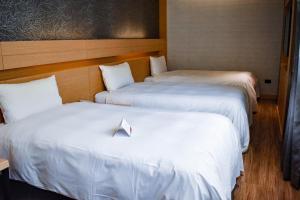 Postel nebo postele na pokoji v ubytování Talmud Hotel Tainan