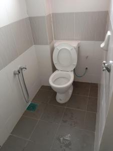 a small bathroom with a toilet in a stall at Maryam kiara kerteh homestay in Kertih