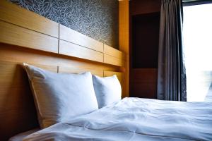 Postel nebo postele na pokoji v ubytování Talmud Hotel Tainan