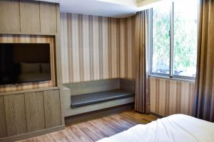 Postel nebo postele na pokoji v ubytování Talmud Hotel Tainan