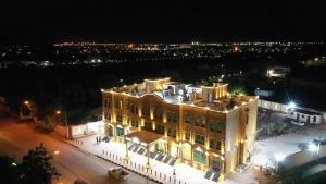 Un grand bâtiment est éclairé la nuit. dans l'établissement Golden Airport Hotel, à Djibouti