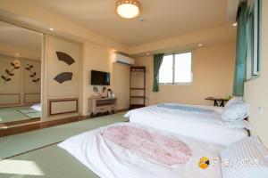Postelja oz. postelje v sobi nastanitve Tong Xin Farmstay