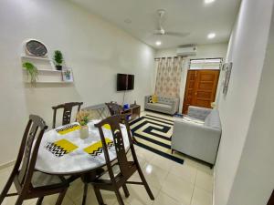 a living room with a dining room table and chairs at ST2167 Arfa Permata Homestay in Masjid Tanah