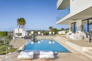 a house with a swimming pool on top of it at Eden Roc in Pòrtol