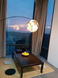 a table in front of a window with a view at Empire Damansara Homes by Cities Homes Malaysia in Petaling Jaya