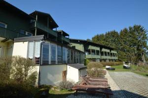 a building with benches in front of it at Apartment Christopherhof 11, Grafenwiesen in Grafenwiesen