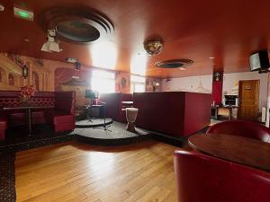 a room with a restaurant with a table and chairs at Les Chambres du Sillon in Pleubian