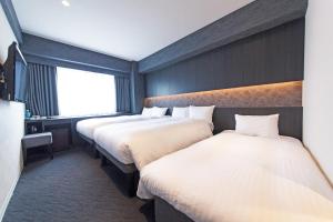 Postel nebo postele na pokoji v ubytování FP HOTELS South-Namba + 19 fotografií