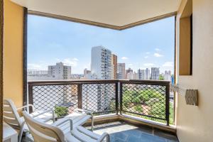 a balcony with chairs and a view of a city at Capital O Park Tower, Campinas in Campinas