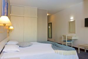 Een bed of bedden in een kamer bij Aparthotel Imperatriz