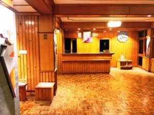 a large room with wooden walls and a wood floor at Surbee Resort Mussoorie in Mussoorie