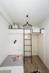 a bedroom with a bunk bed with a ladder at Апартаменти біля Оперного Театру in Lviv