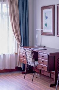 a desk with a chair next to a window at 314 on Clark Guest House in Pretoria