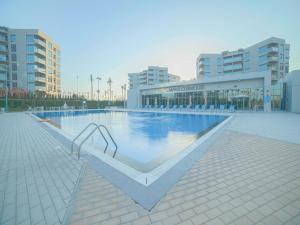 a large swimming pool in front of a building at OYO 617 Home 610, Mag 555 in Dubai