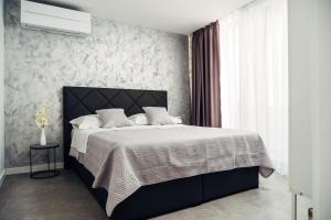 a bedroom with a large bed with a black headboard at Villa Jadran in Promajna +29 photos