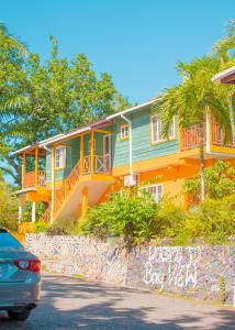 a house with a car parked in front of it at Bay View Eco Resort & Spa in Port Antonio
