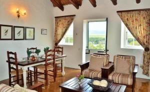 a living room with a table and chairs at De Hoop Collection - Vlei Cottages in De Hoop Nature Reserve