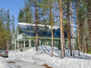 Ein Haus im Wald im Schnee in der Unterkunft Holiday Home Huuhkalinna by Interhome in Syöte