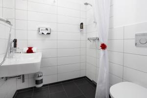 a white bathroom with a sink and a toilet at INA Boutique 072 Hamburg St Georg in Hamburg +38 photos