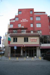 a red building with a hotel bondo on top of it at Hotel Bordo in Plovdiv