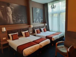 Postel nebo postele na pokoji v ubytování Hotel Washington