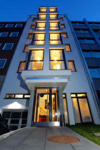 a tall white building with lights on at INA Boutique 072 Hamburg St Georg in Hamburg