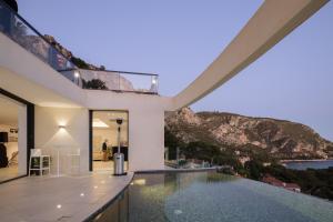 a house with a swimming pool with a view at Villa Paradise in Èze